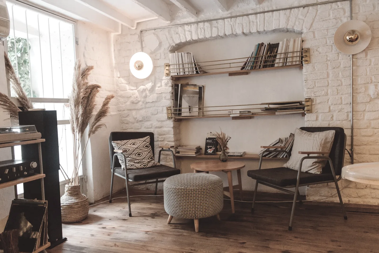 A quiet counselling room with two soft chairs, plants and warm daylight